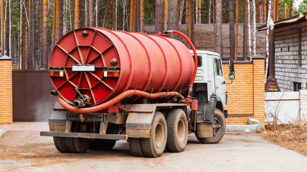 Red gully bowser vacuum tanker with suction hoses